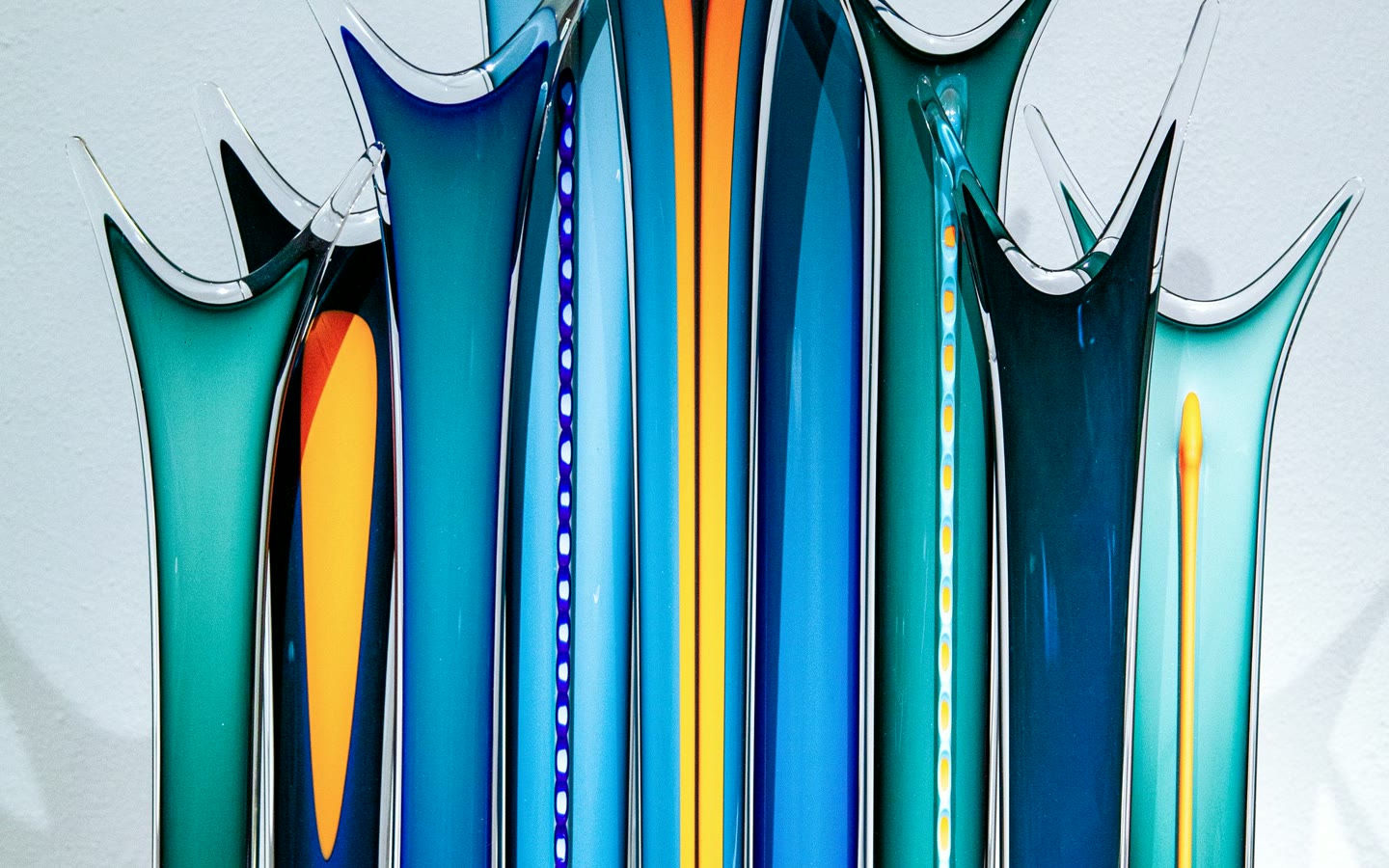 A colorful glass sculpture photographed on a clean background