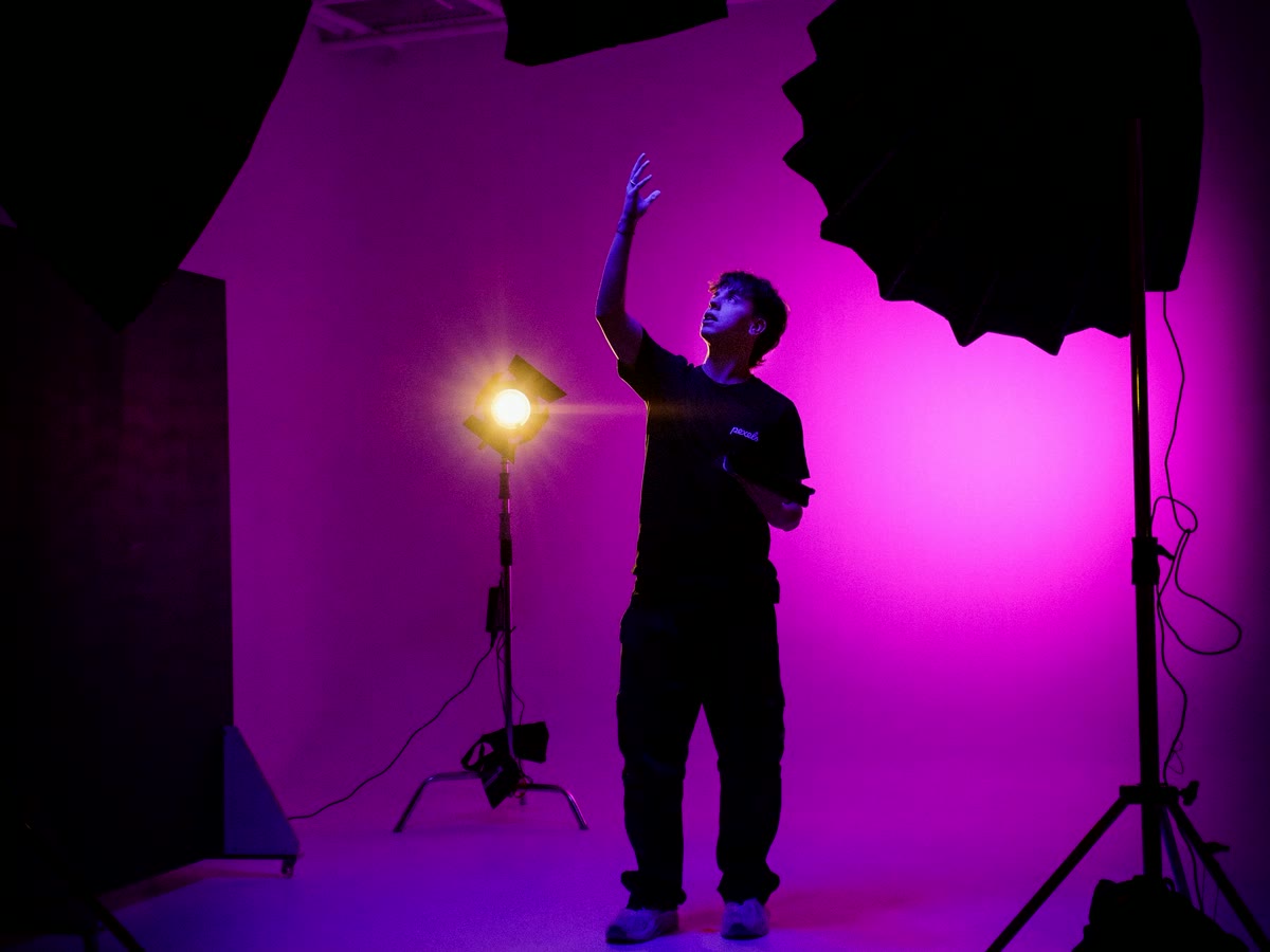 A photographer shaping a shot inside a colorful studio